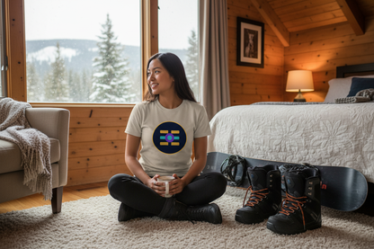Asian woman wearing The Boards Shop T in a cozy ski chalet bedroom